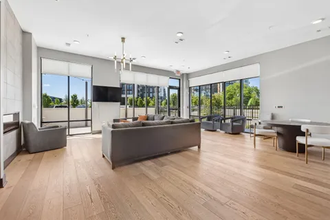 a room with wooden floor and ceiling fan