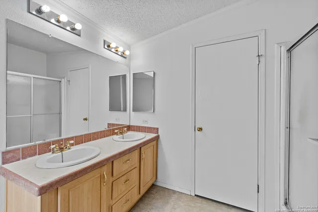 a bathroom with a sink double vanity and a mirror