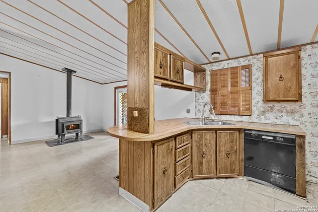 a kitchen with stainless steel appliances granite countertop a sink and cabinets