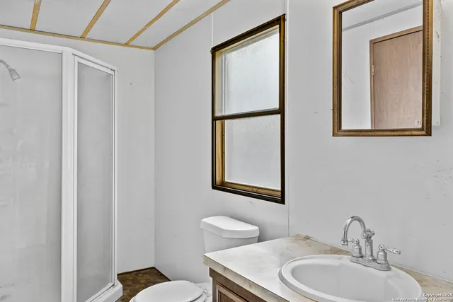 a view of a big room with windows and bathroom