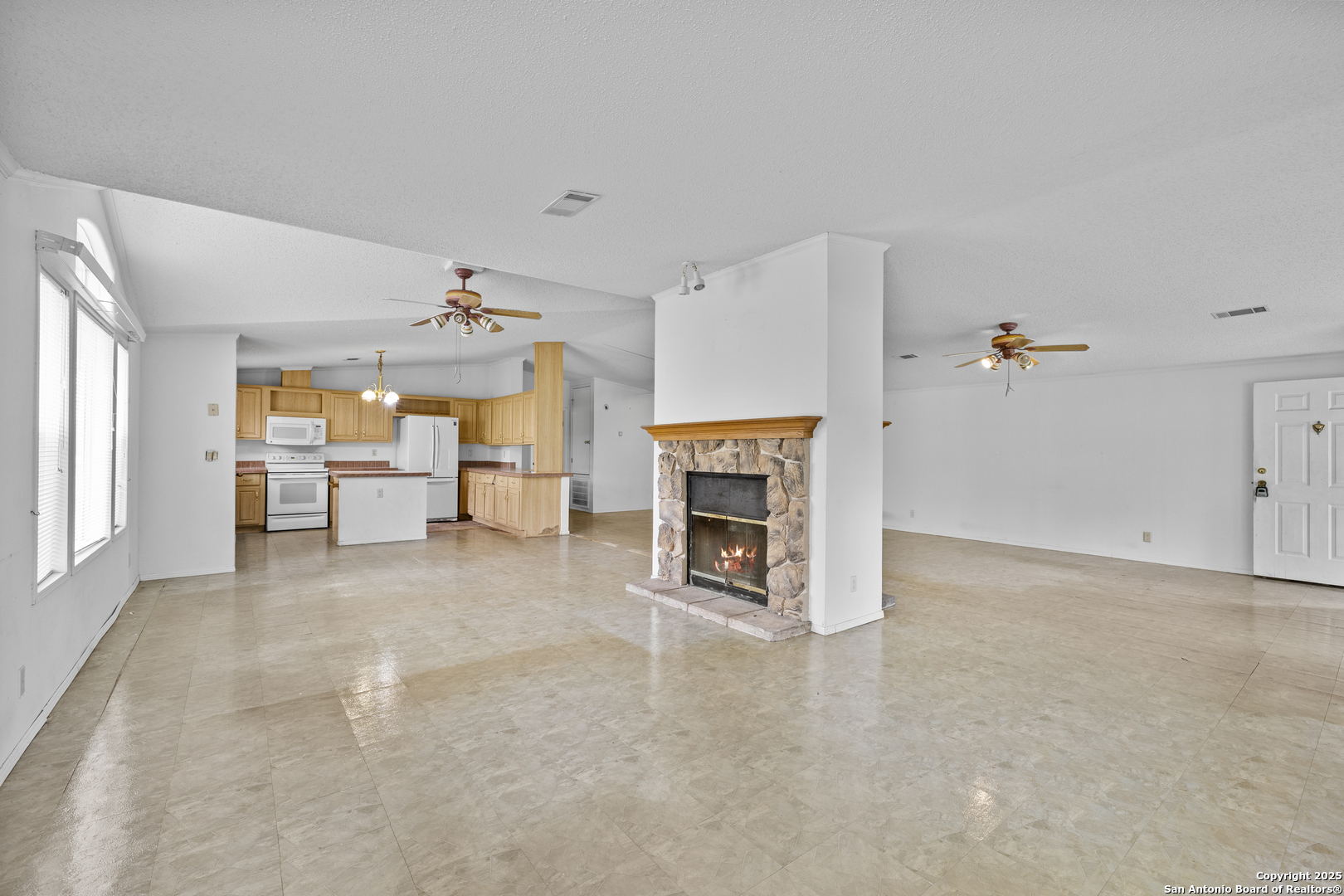 1189 Vivroux Ranch Road Seguin, TX 78155 - Photo 5 of 24 an empty room with furniture and fireplace