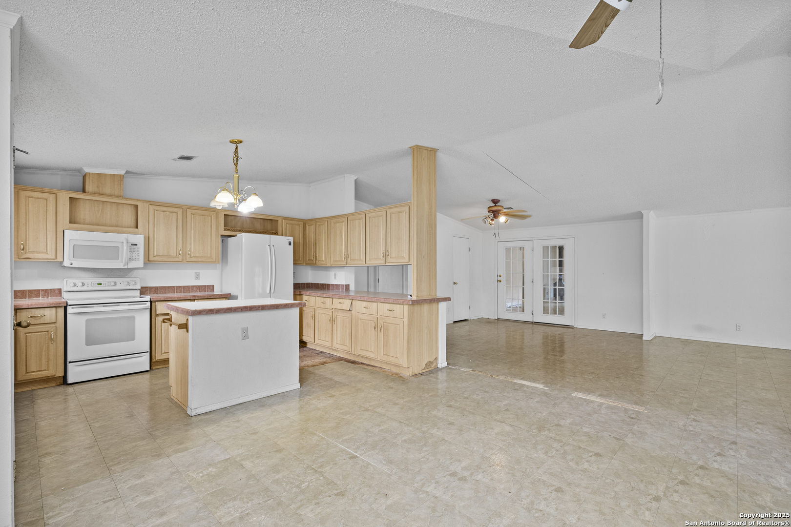 1189 Vivroux Ranch Road Seguin, TX 78155 - Photo 7 of 24 a large white kitchen with cabinets a sink and a stove