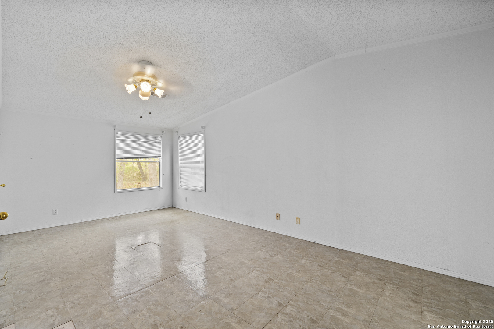 1189 Vivroux Ranch Road Seguin, TX 78155 - Photo 8 of 24 an empty room with a window and a chandelier fan