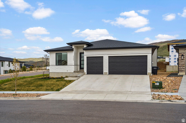 3349 Oxford Loop Morgan, UT 84050 - Photo 36 of 47 Prairie-style house featuring a mountain view, an attached garage, driveway, a front lawn, and roof with shingles