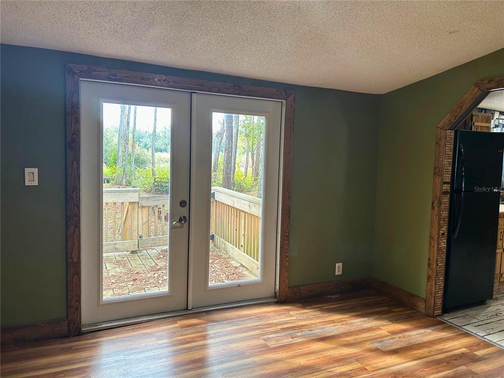 9867 Jerome Drive New Port Richey, FL 34654 - Photo 17 of 30 a view of an empty room with wooden floor and a window