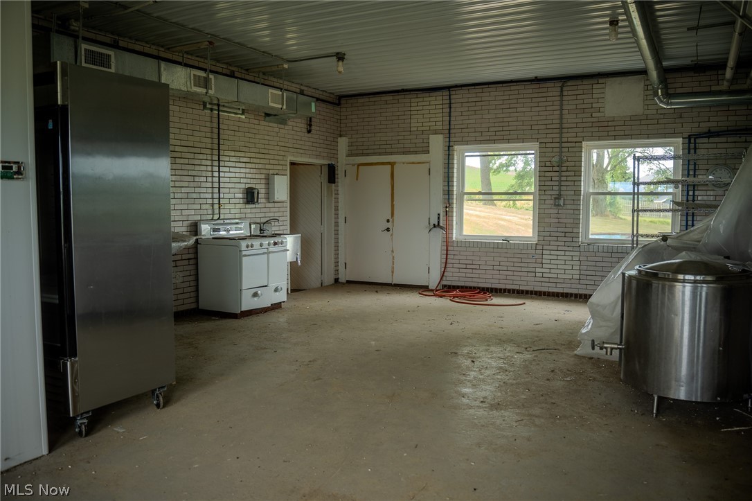 513 Ragersville Road Northwest Sugarcreek, OH 44681 - Photo 19 of 50 Garage with stainless steel fridge