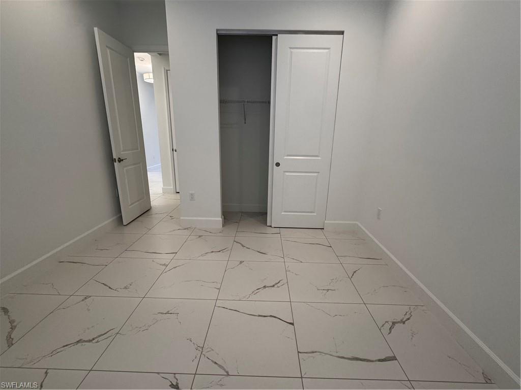 2864 Bloomfield Way Naples, FL 34112 - Photo 15 of 40 an empty room with a mirror
