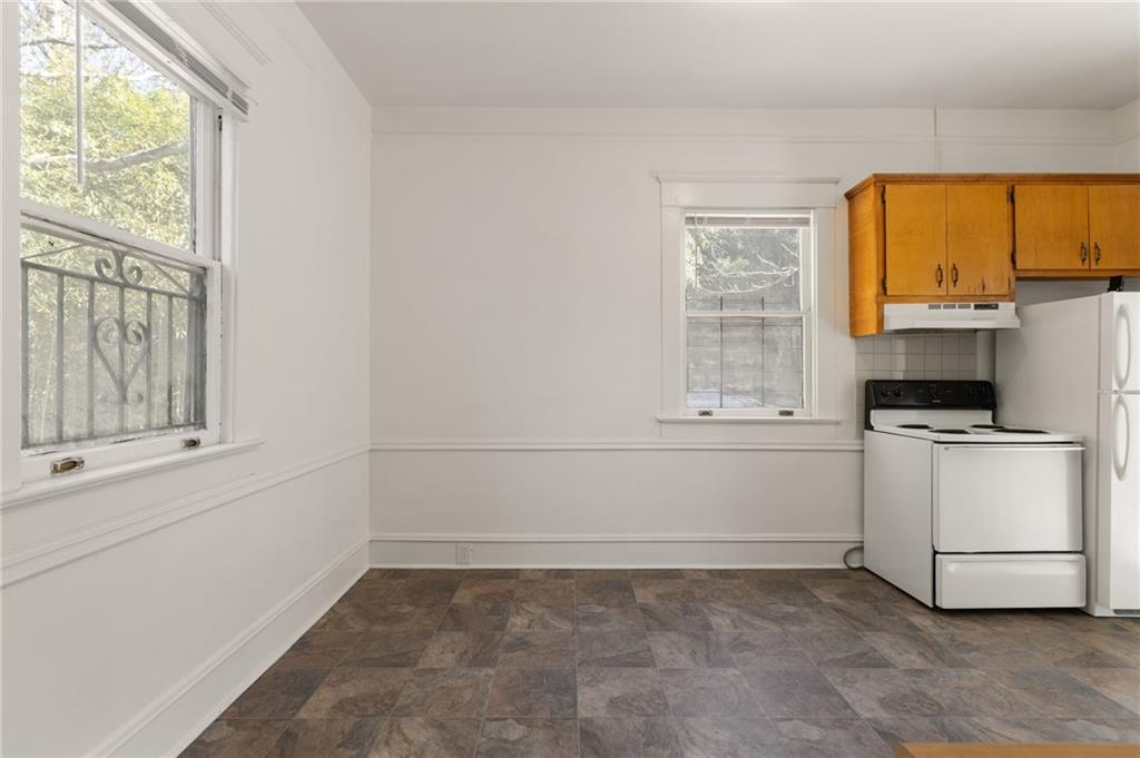 120 South Candler Street Decatur, GA 30030 - Photo 40 of 40 a view of a kitchen with wooden floor and electronic appliances