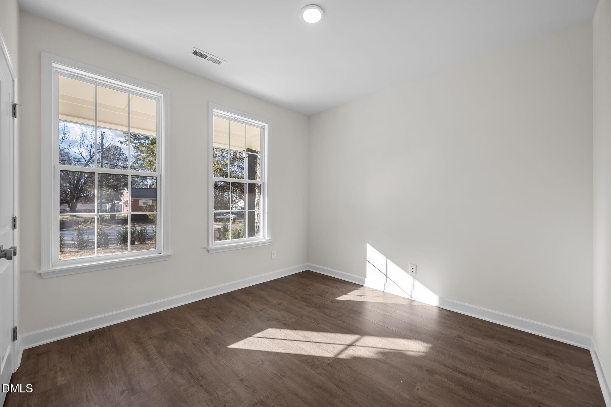 3505 Skycrest Drive Raleigh, NC 27604 - Photo 12 of 45 an empty room with wooden floor and windows