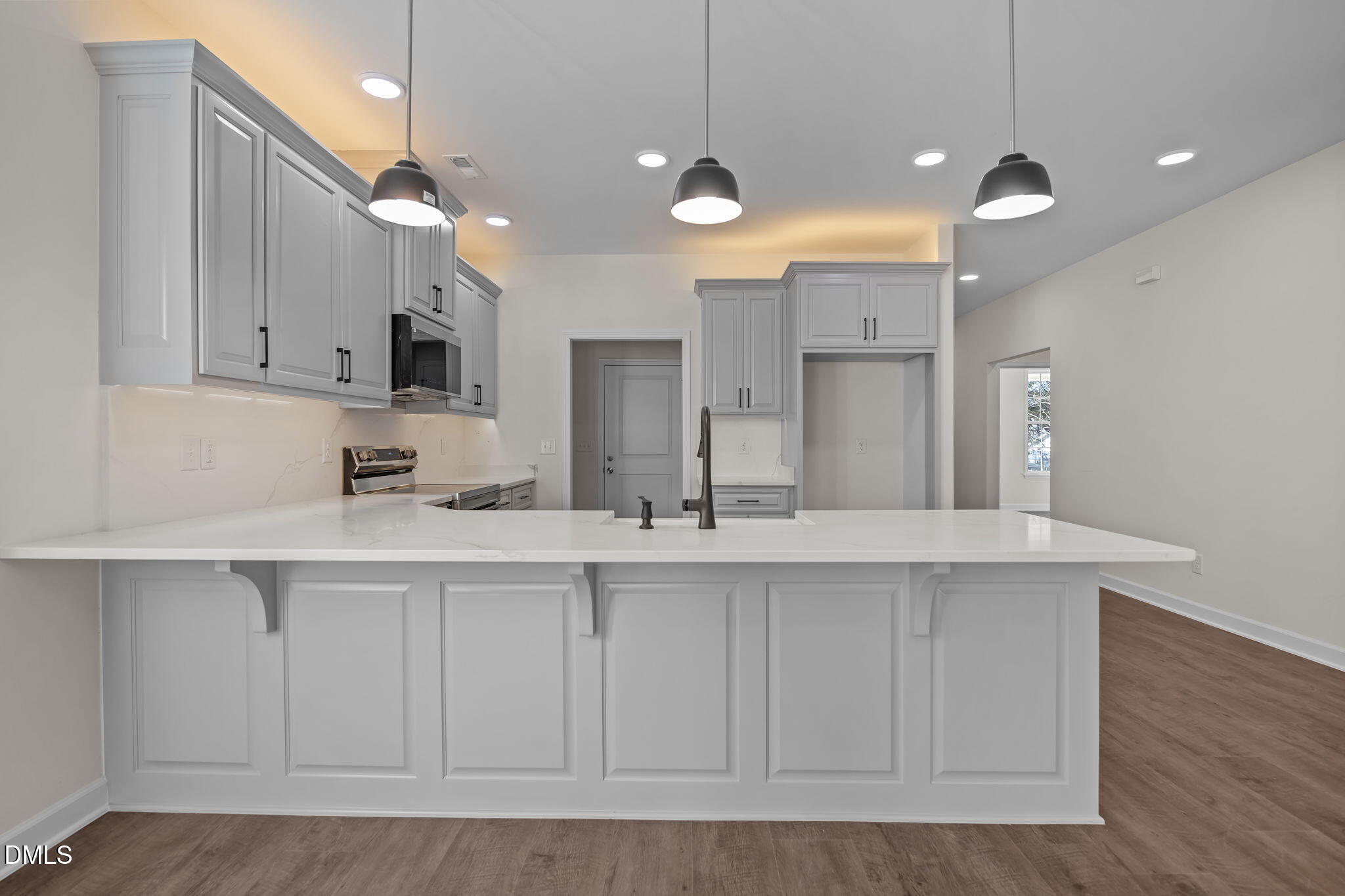 3505 Skycrest Drive Raleigh, NC 27604 - Photo 17 of 45 a kitchen with kitchen island white cabinets and stainless steel appliances