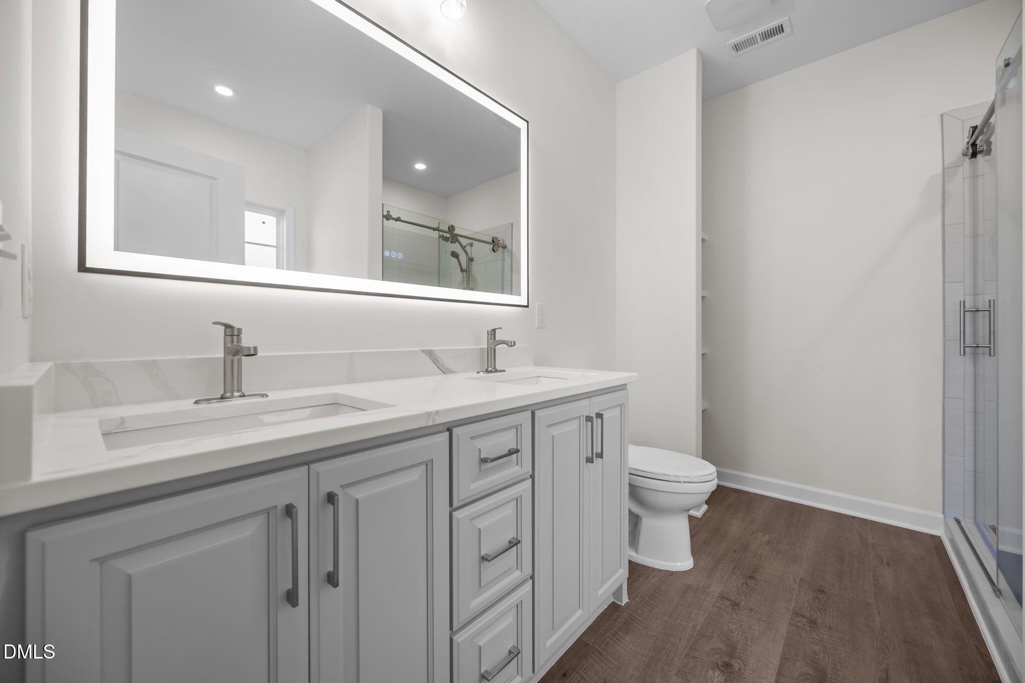 3505 Skycrest Drive Raleigh, NC 27604 - Photo 27 of 45 a bathroom with a toilet sink and mirror