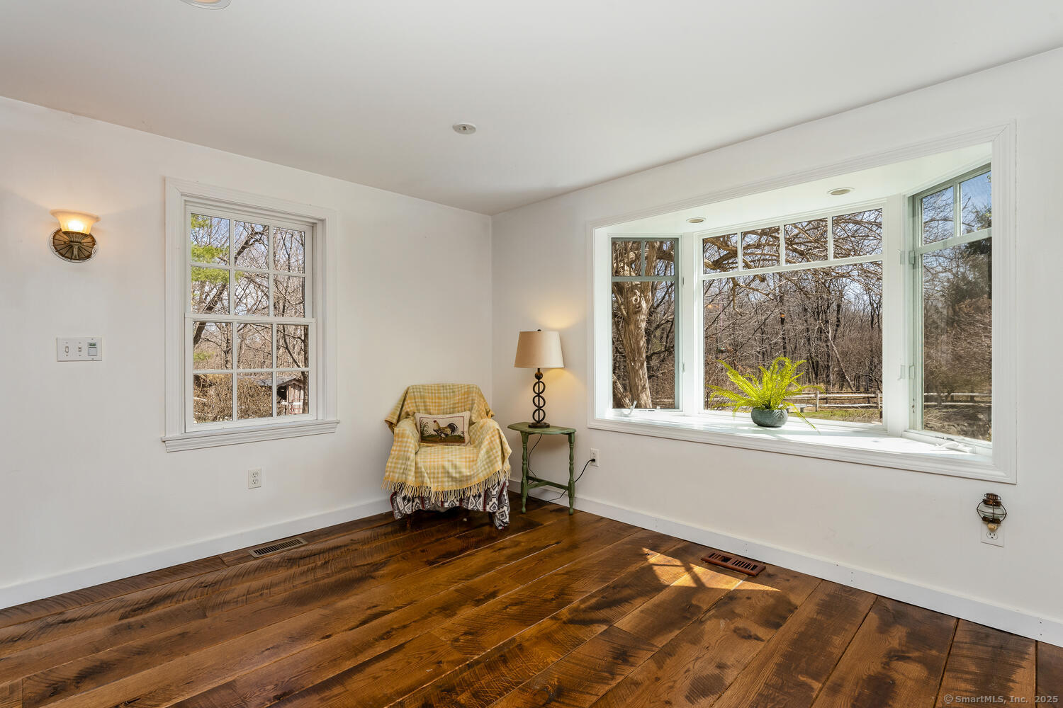 175 Mountain Road Wilton, CT 06897 - Photo 18 of 40 a view of a bedroom with wooden floor and a window