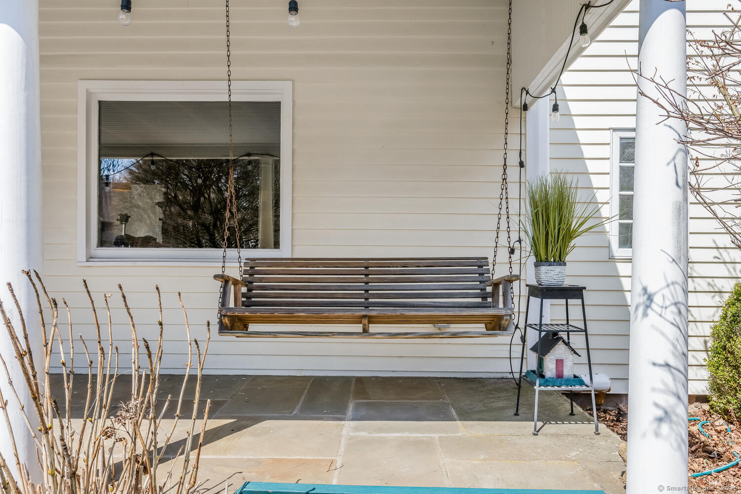 175 Mountain Road Wilton, CT 06897 - Photo 2 of 40 a view of a balcony with a chair and floor to ceiling window