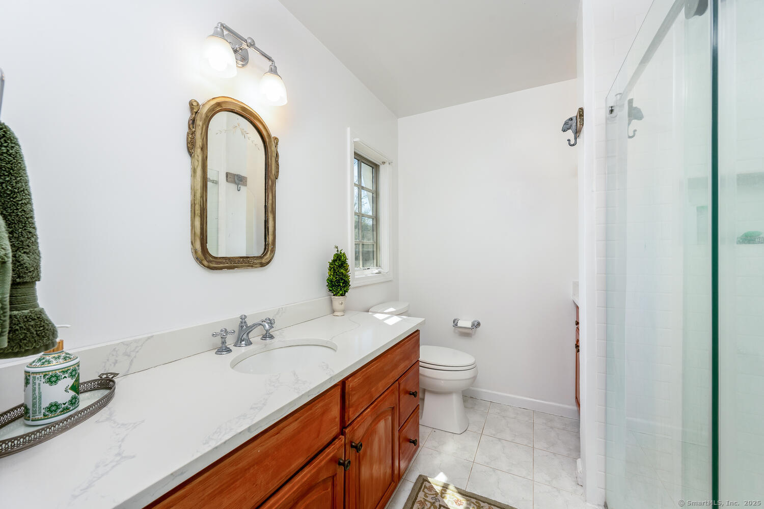 175 Mountain Road Wilton, CT 06897 - Photo 24 of 40 a bathroom with a double vanity sink toilet and a mirror