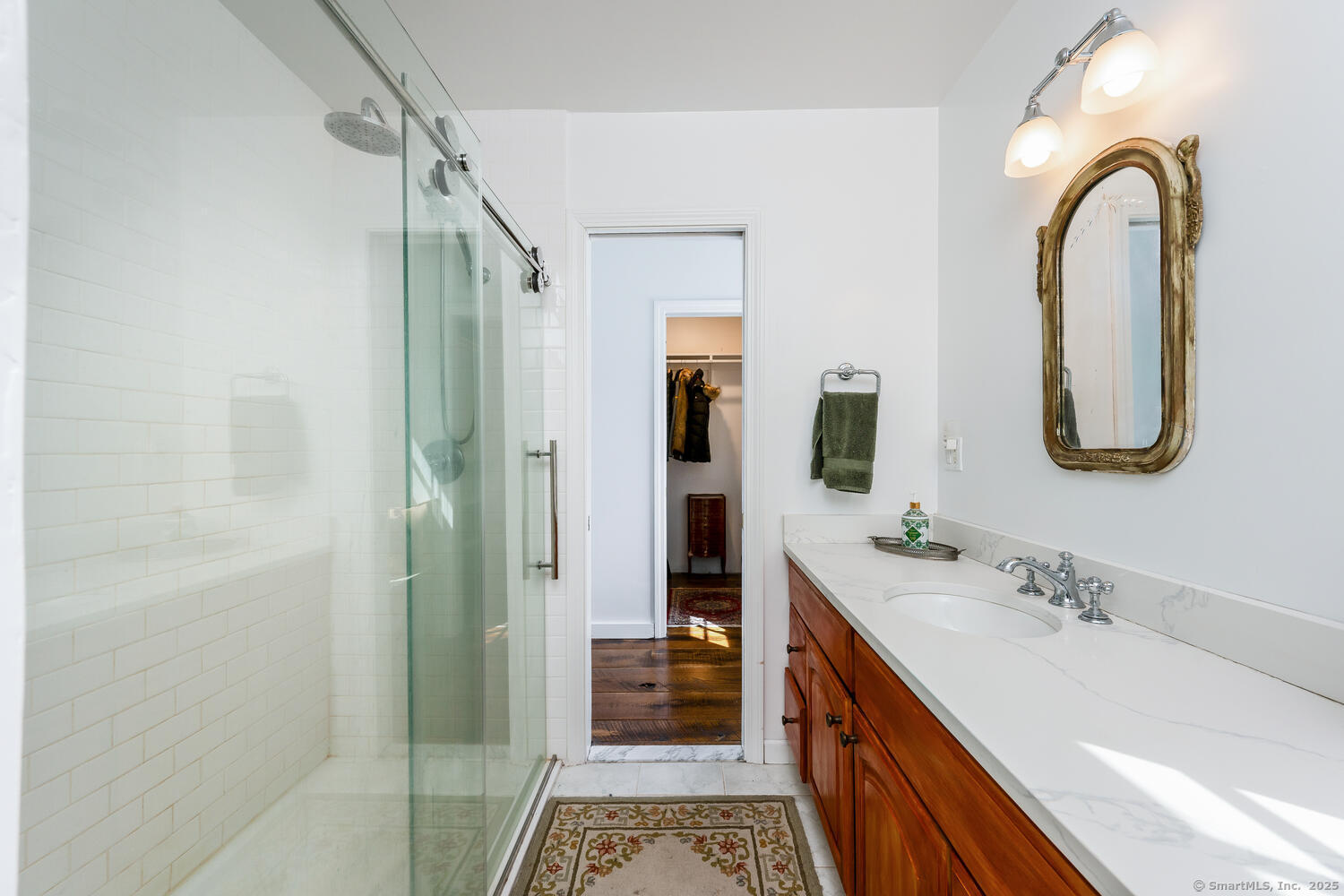 175 Mountain Road Wilton, CT 06897 - Photo 25 of 40 a bathroom with a double vanity sink a two mirror a shower and a bathtub