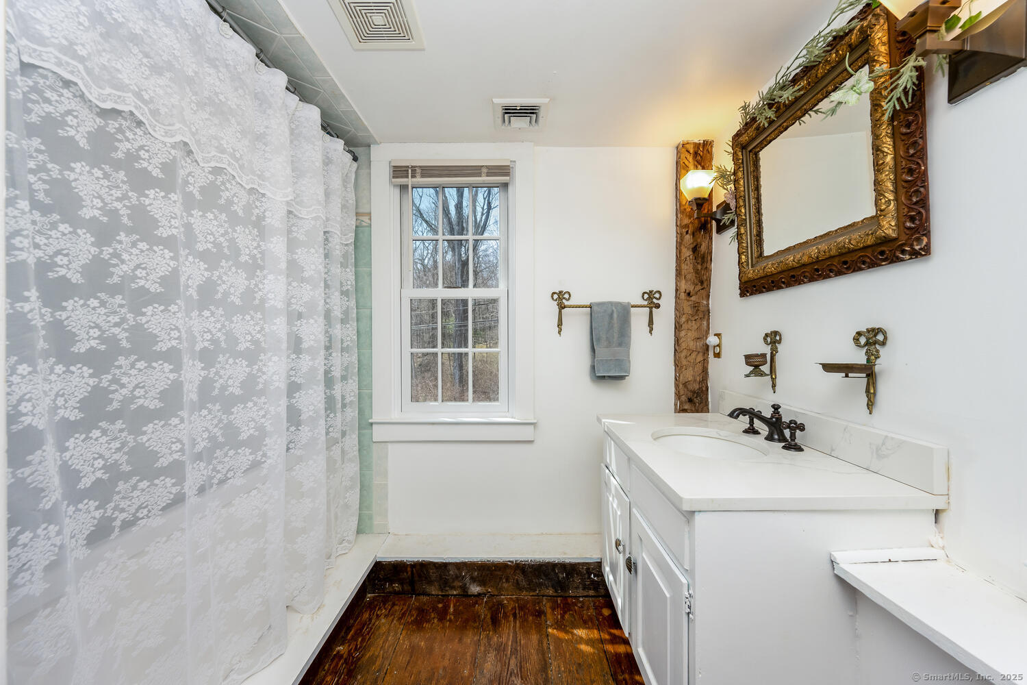 175 Mountain Road Wilton, CT 06897 - Photo 29 of 40 a bathroom with a sink a vanity and a mirror