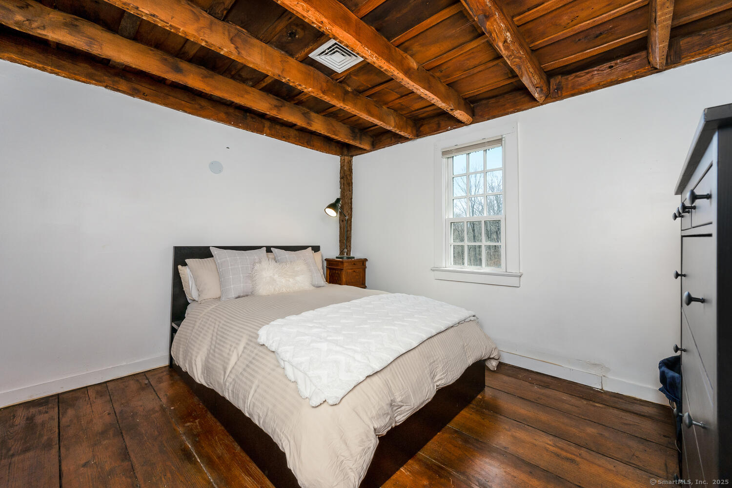 175 Mountain Road Wilton, CT 06897 - Photo 30 of 40 a bed sitting in a bedroom next to a window