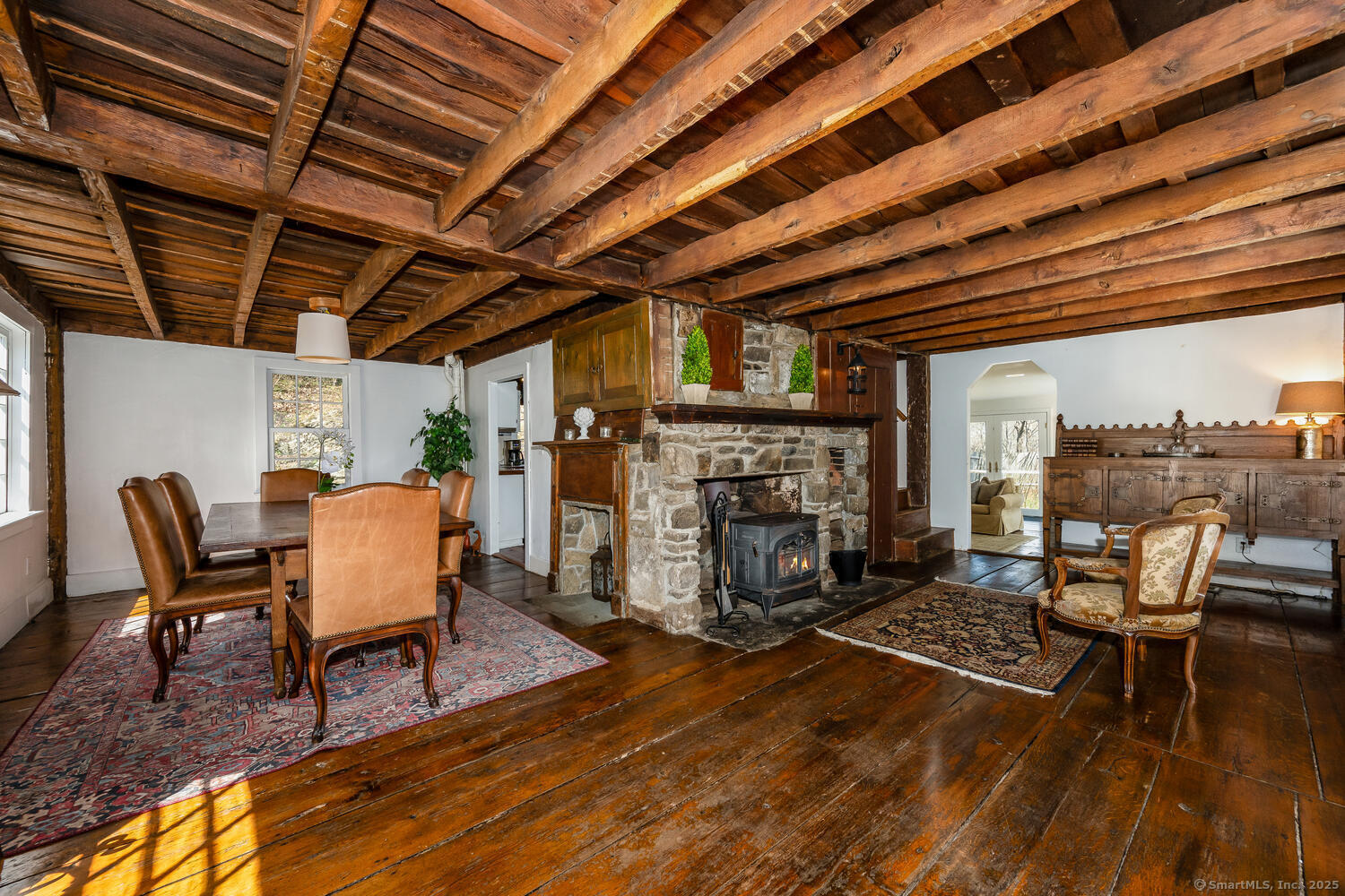 175 Mountain Road Wilton, CT 06897 - Photo 5 of 40 a dining room with furniture a fireplace and wooden floor
