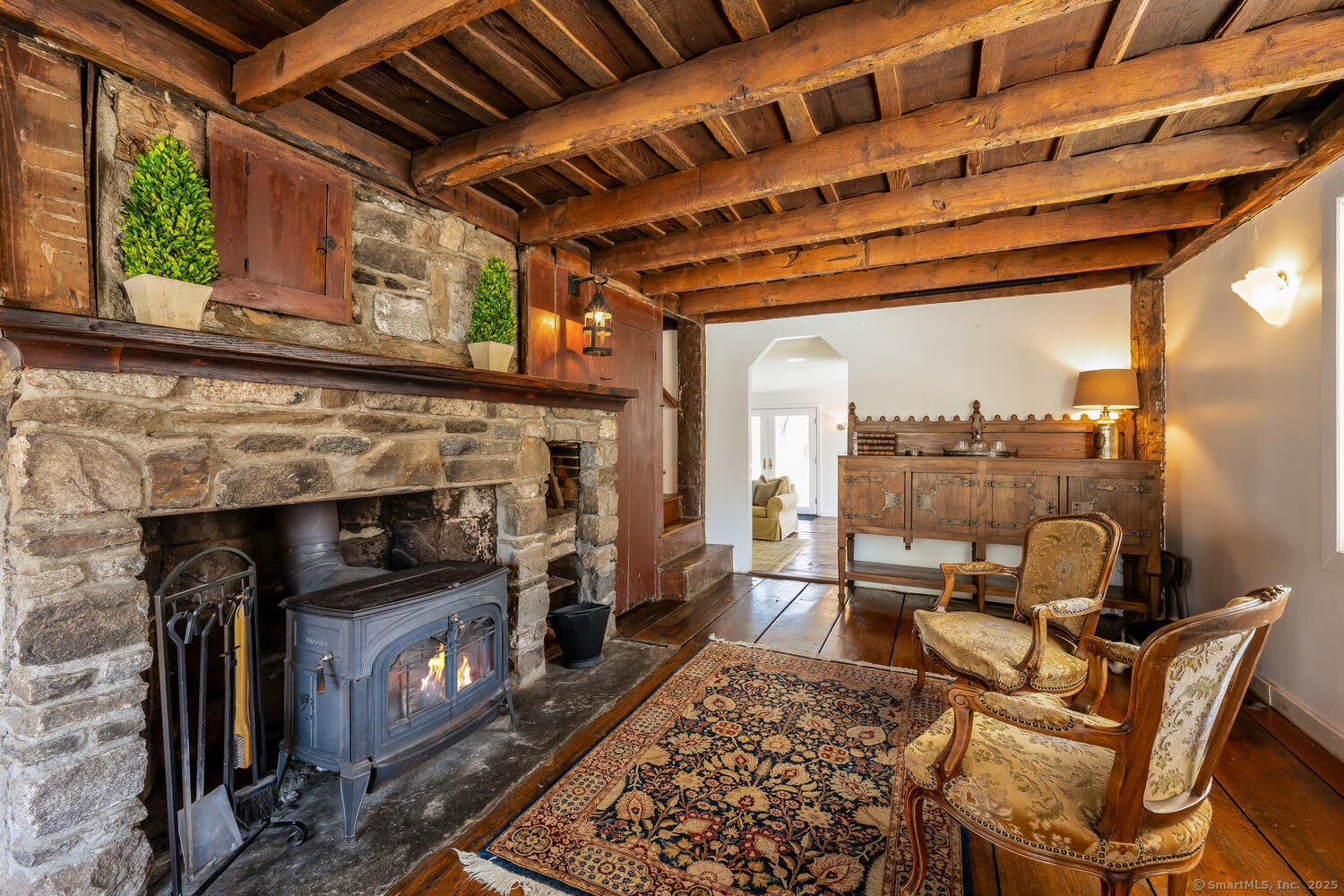 175 Mountain Road Wilton, CT 06897 - Photo 6 of 40 a living room with furniture a fireplace a flat screen tv and next to a window