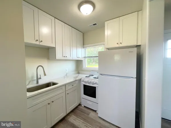 a kitchen with refrigerator a sink and cabinets