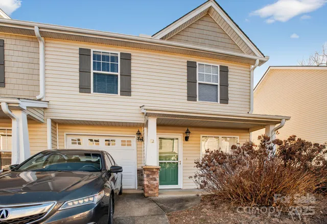 a view of a car park in front of house