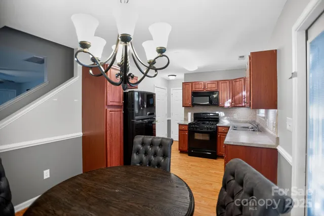 a kitchen with stainless steel appliances granite countertop a refrigerator and microwave