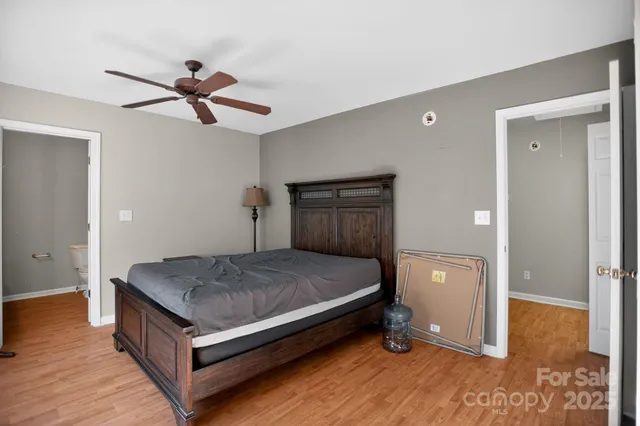 a bed room with a bed and a ceiling fan