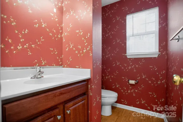 a bathroom with a sink a toilet and mirror
