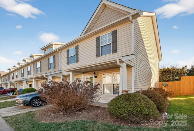 a view of a house with a small yard and plants