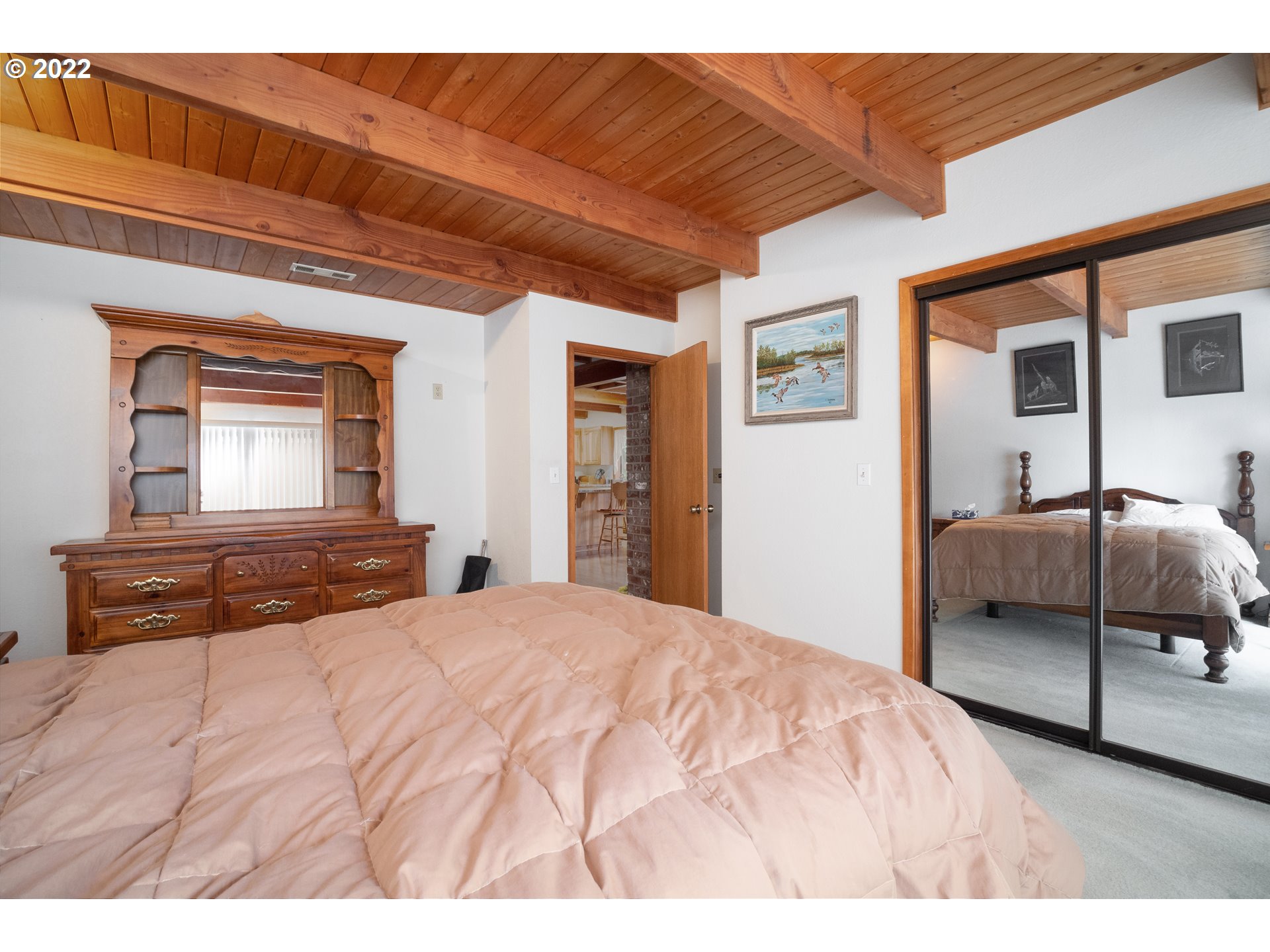 378 Racoon Road Oakland, OR 97462 - Photo 12 of 32 a bedroom with a bed and a large mirror