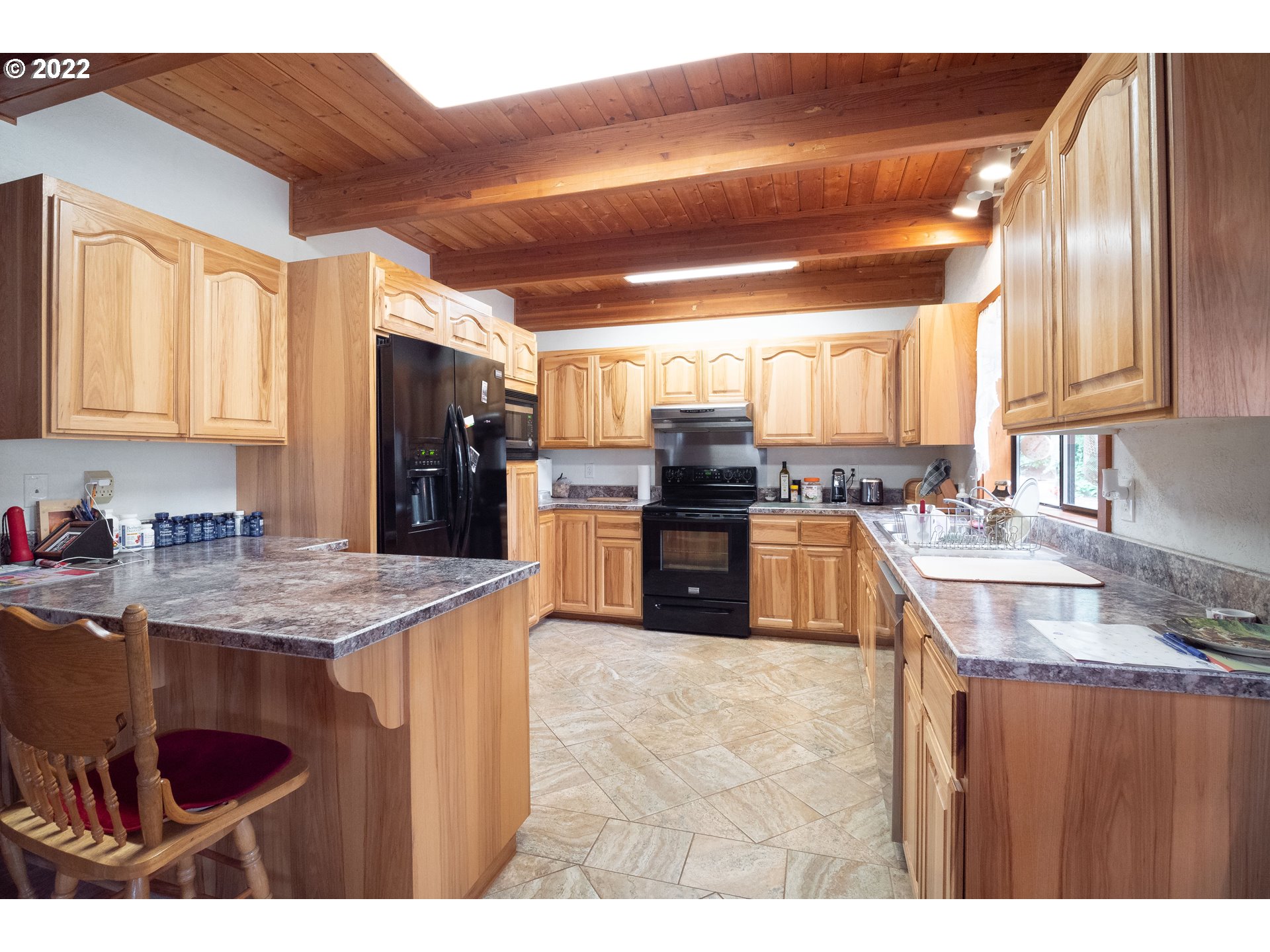 378 Racoon Road Oakland, OR 97462 - Photo 9 of 32 a kitchen with stainless steel appliances granite countertop a sink stove and refrigerator