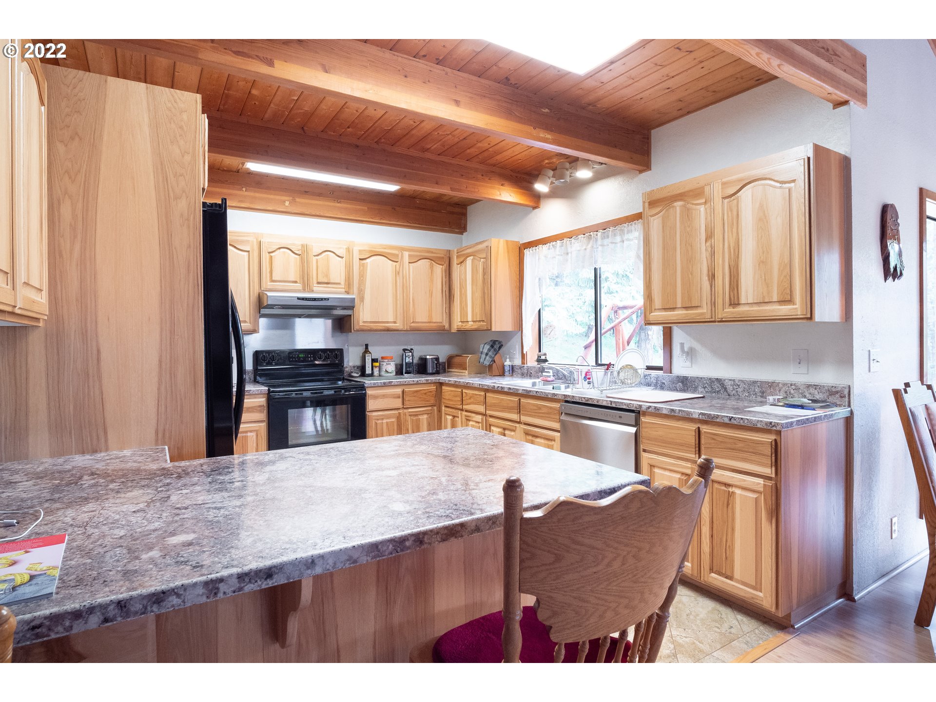 378 Racoon Road Oakland, OR 97462 - Photo 10 of 32 a kitchen with stainless steel appliances granite countertop a sink refrigerator and cabinets