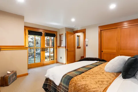 a bedroom with a large bed and a closet