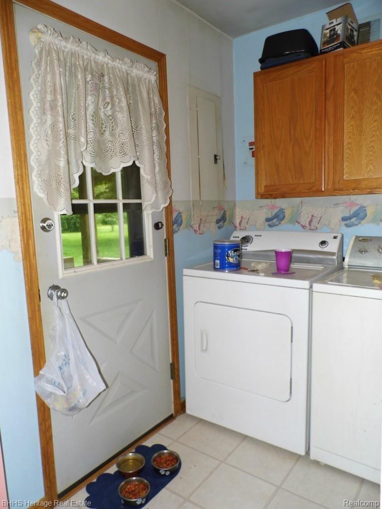 6950 West Sober Road Fowlerville, MI 48836 - Photo 32 of 32 Laundry area with door to back deck