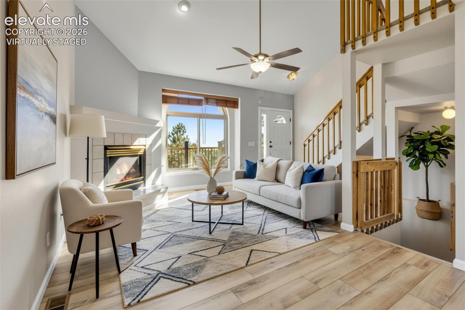 17370 Sweet Road Peyton, CO 80831 - Photo 16 of 47 VIRTUALLY STAGED. Welcome inside...Living area with a tiled gas fireplace, new LVP flooring, new interior paint, high ceilings and tons of natural light.