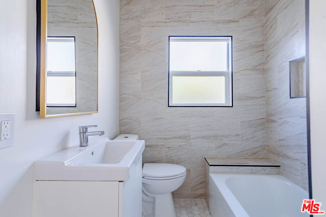 4309 Burns Avenue Los Angeles, CA 90029 - Photo 11 of 16 a bathroom with a sink a toilet and window