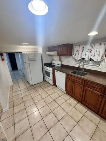 a kitchen with stainless steel appliances a sink and cabinets