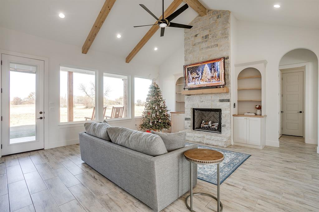 8140 Lavender Road Springtown, TX 76082 - Photo 13 of 40 a living room with furniture and a fireplace