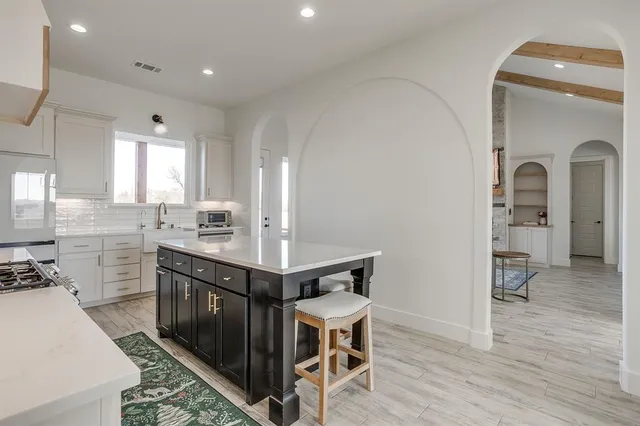 a kitchen with sink and cabinets