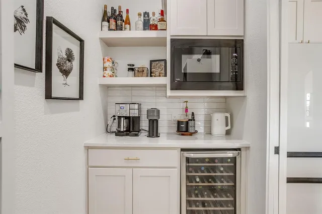 a hallway with cabinets and wooden floor