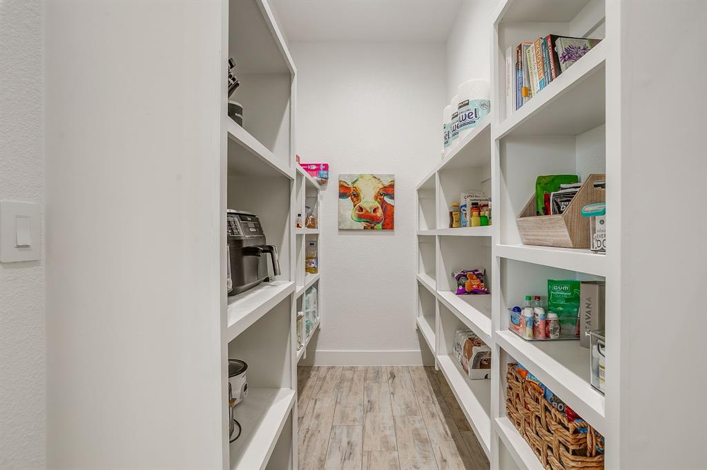 8140 Lavender Road Springtown, TX 76082 - Photo 20 of 40 a hallway with cabinets and wooden floor