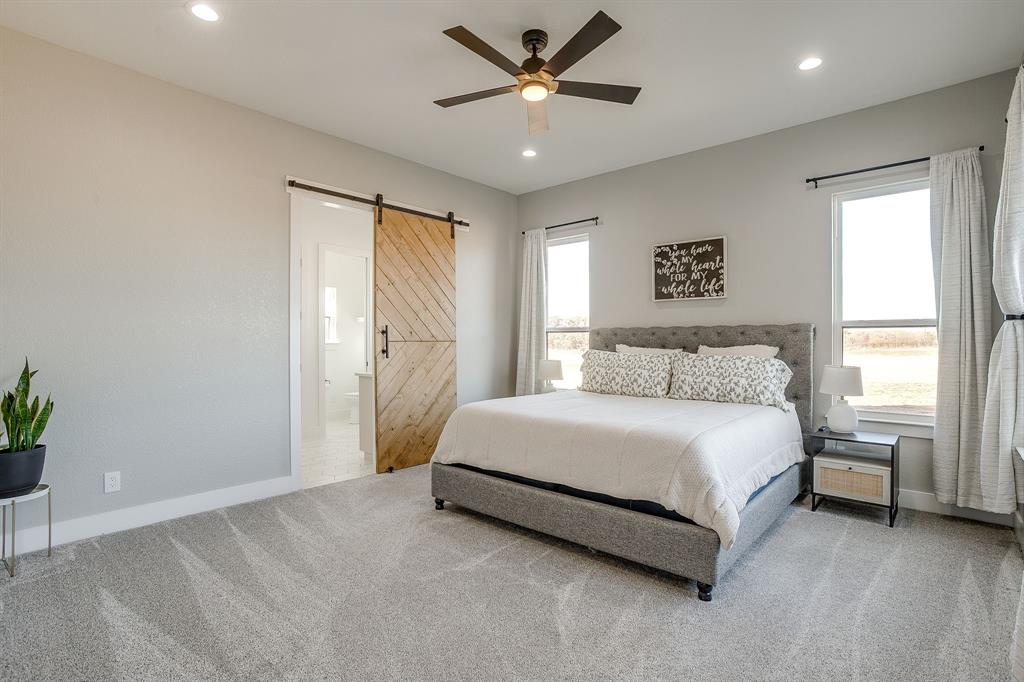 8140 Lavender Road Springtown, TX 76082 - Photo 21 of 40 a spacious bedroom with a bed and a window