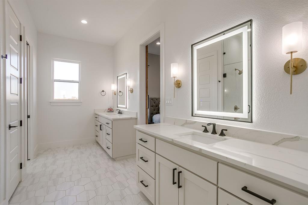 8140 Lavender Road Springtown, TX 76082 - Photo 23 of 40 a bathroom with double vanity sink a mirror and a shower