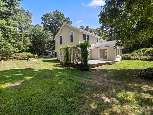 a view of a house with yard and sitting area