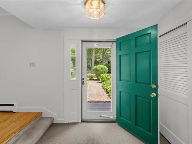 an entryway with a window and a livingroom
