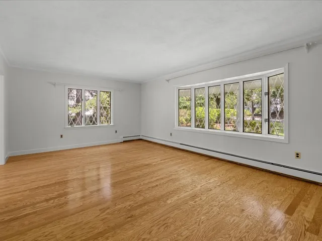 wooden floor in an empty room with a window