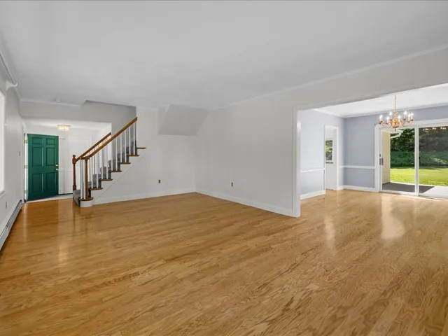a view of empty room with floor to ceiling window and potted plants