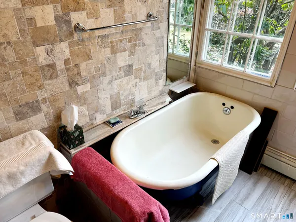 a bathroom with a tub and a window