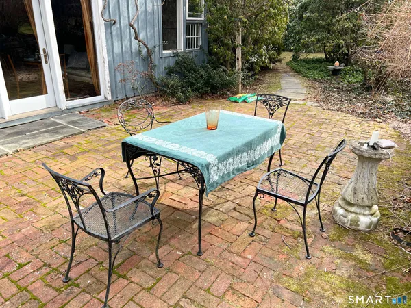 a view of a patio with table and chairs and potted plants