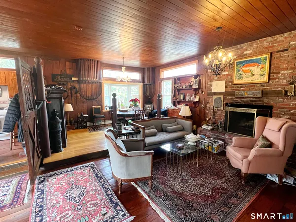 a living room with patio furniture and a fireplace